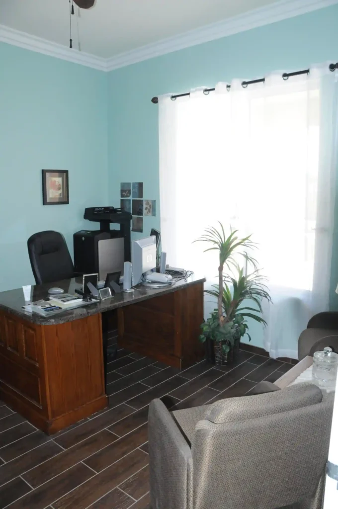 Office image of Nevada memory care for gallery section. A table with desktop and some office accessories and a set of sofas
